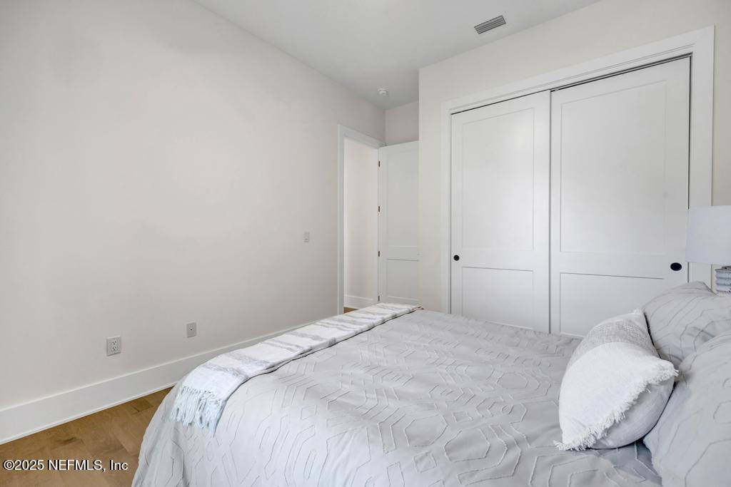 552 Seagate Avenue Neptune Beach, FL 32266 - Photo 24 of 29 a bedroom with a bed and a night stand