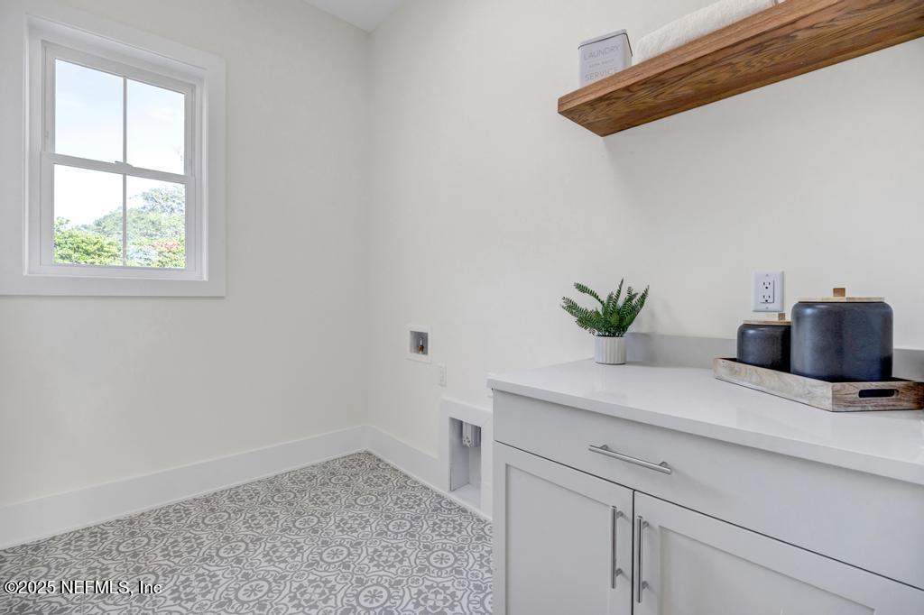 552 Seagate Avenue Neptune Beach, FL 32266 - Photo 25 of 29 a view of kitchen with a potted plant on the counter and cabinets