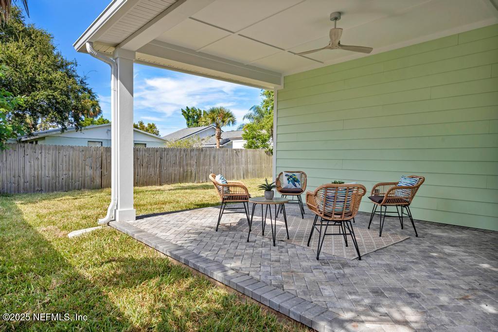552 Seagate Avenue Neptune Beach, FL 32266 - Photo 7 of 29 a view of a patio with table and chairs next to a yard