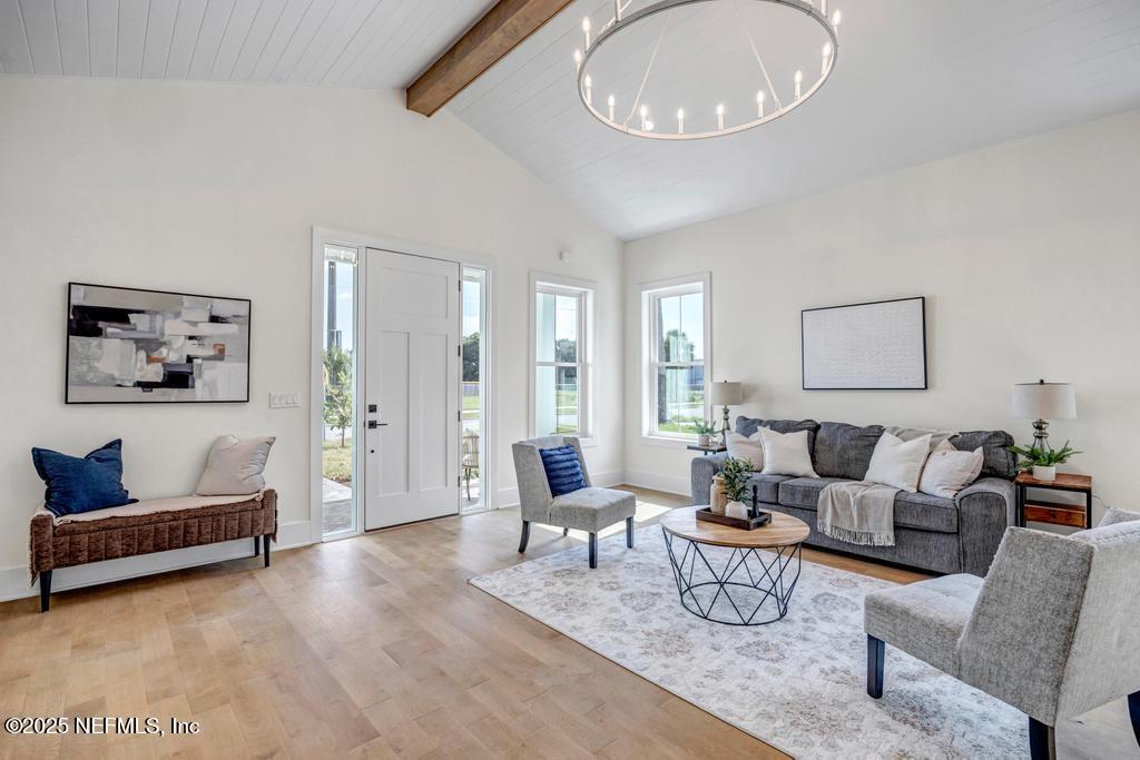 552 Seagate Avenue Neptune Beach, FL 32266 - Photo 9 of 29 a living room with furniture and a large window