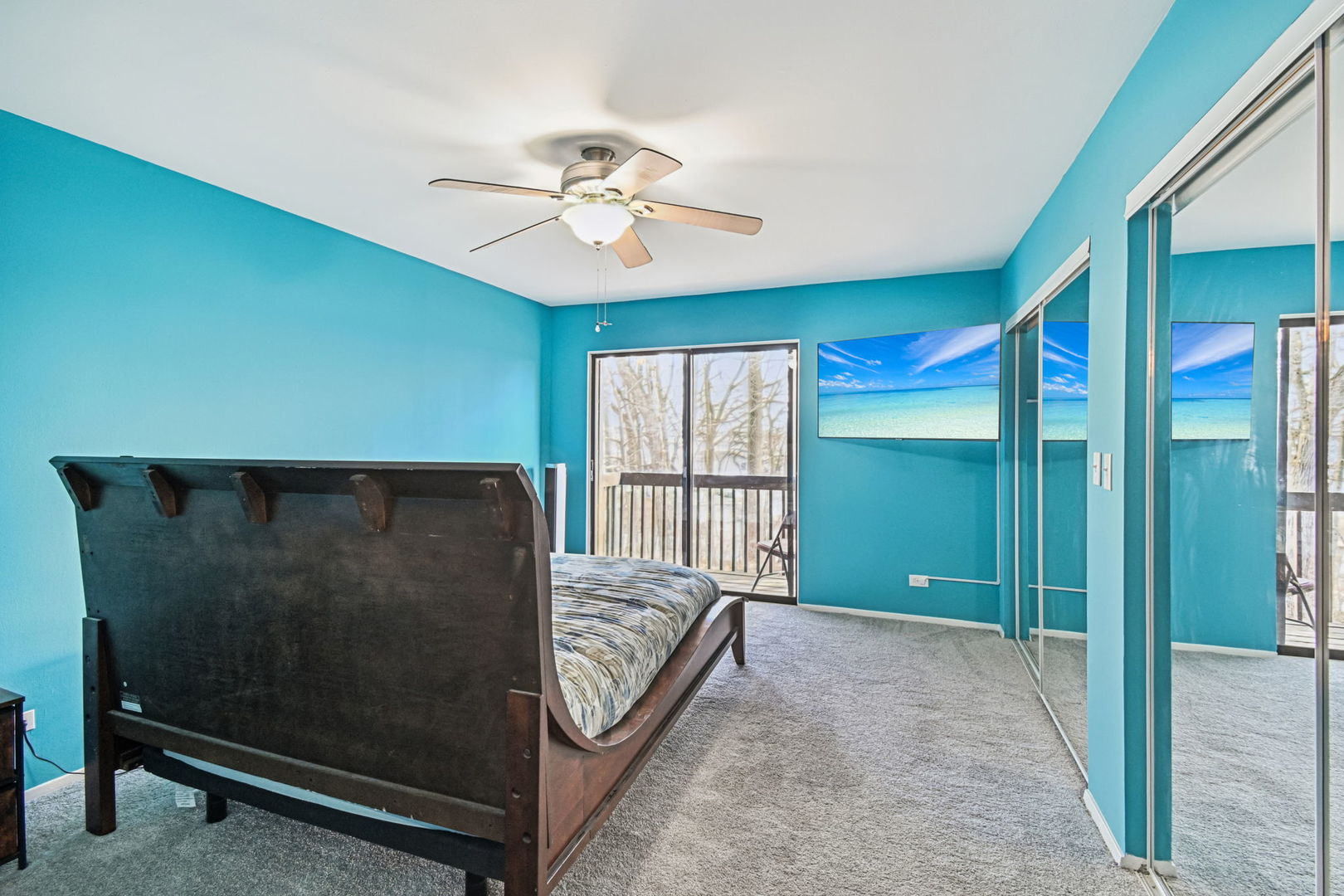 67 Woodhills Bay Road Fox Lake, IL 60020 - Photo 12 of 27 a living room with a large bed and a chandelier