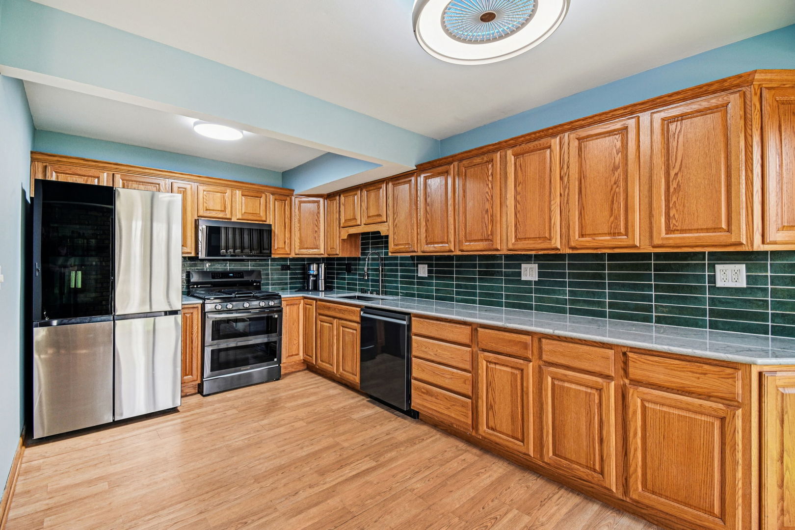 67 Woodhills Bay Road Fox Lake, IL 60020 - Photo 9 of 27 a kitchen with stainless steel appliances a refrigerator sink and cabinets