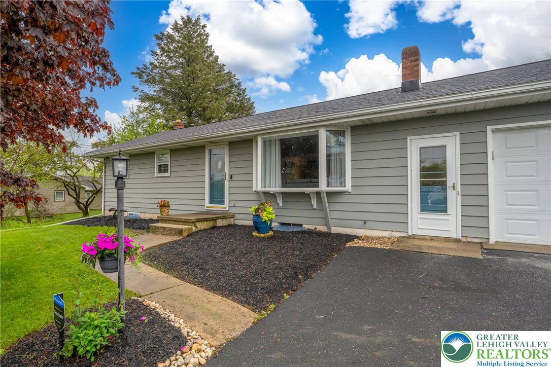 677 English Road Bath, PA 18014 - Photo 1 of 26 a front view of a house with flower plants