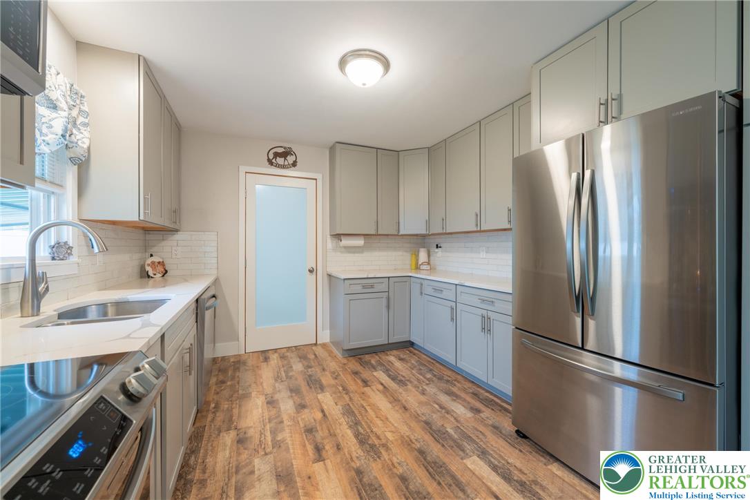 677 English Road Bath, PA 18014 - Photo 11 of 26 a kitchen with a refrigerator sink and white cabinets