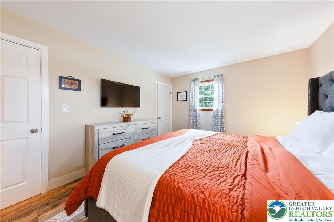 677 English Road Bath, PA 18014 - Photo 17 of 26 a bedroom with a bed and a flat tv screen on dresser