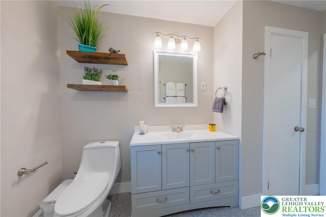677 English Road Bath, PA 18014 - Photo 19 of 26 a bathroom with a toilet a sink and mirror