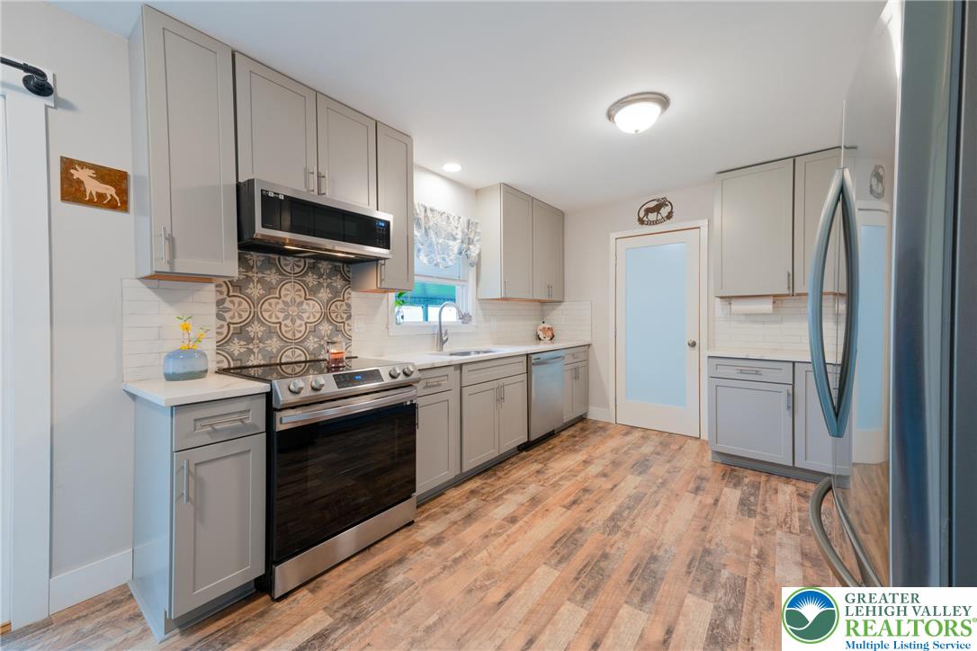 677 English Road Bath, PA 18014 - Photo 8 of 26 a kitchen with stainless steel appliances a stove a sink and a refrigerator