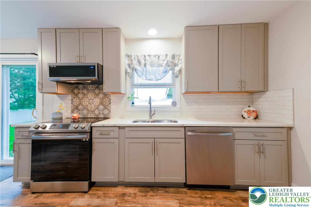 677 English Road Bath, PA 18014 - Photo 9 of 26 a kitchen with stainless steel appliances granite countertop a sink stove and cabinets