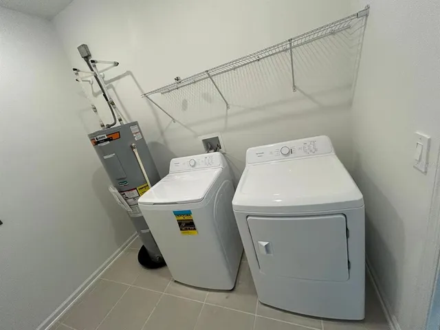 a view of a hallway with wooden floor and a window