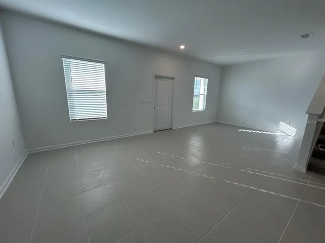 an empty room with a empty space and windows