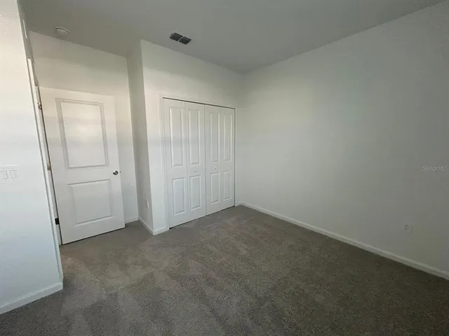 an empty room with closet area