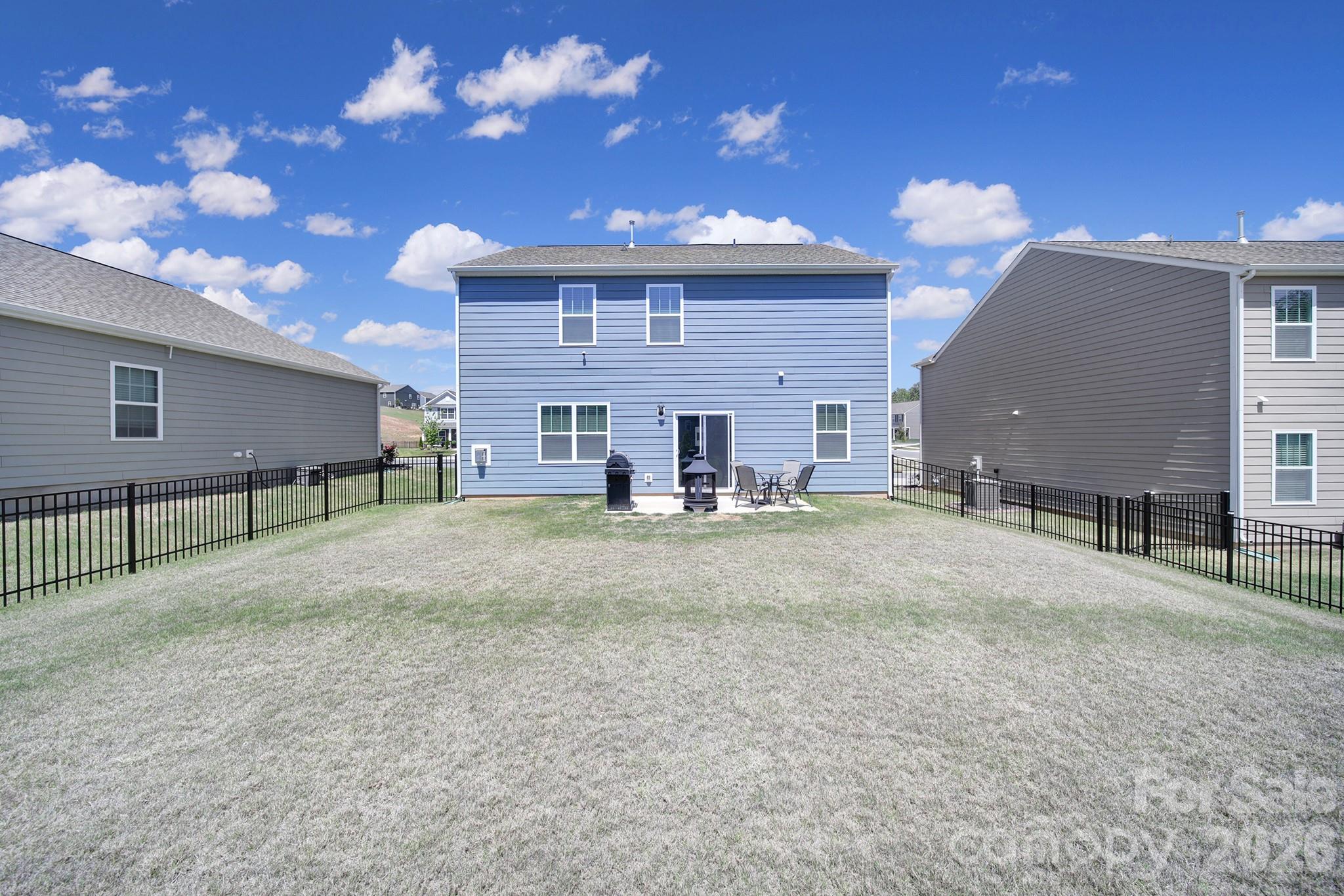 107 Spring Hall Court Troutman, NC 28166 - Photo 26 of 28 a view of a house with a yard and a sitting area