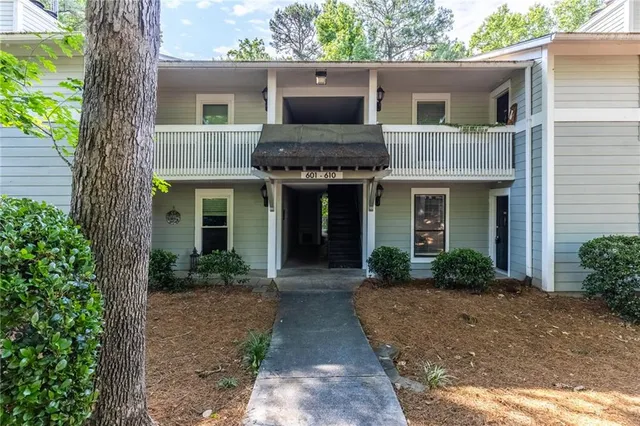 a front view of a house with garden and porch