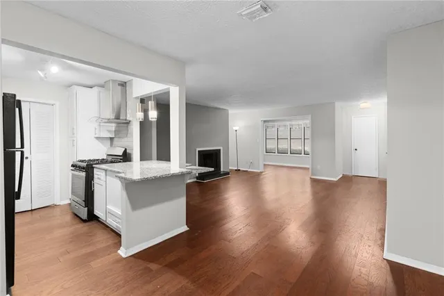 a view of kitchen with cabinets and wooden floor