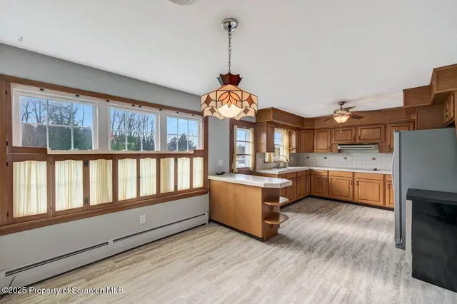 a kitchen with stainless steel appliances granite countertop a stove and a refrigerator