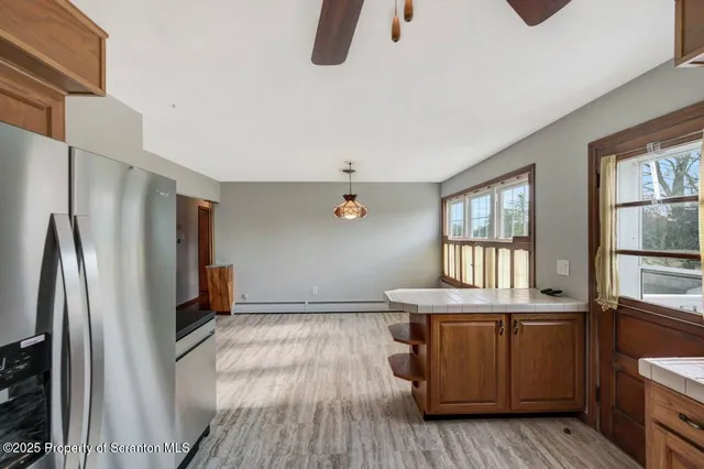 a kitchen with granite countertop a stove a sink and dishwasher with wooden floor