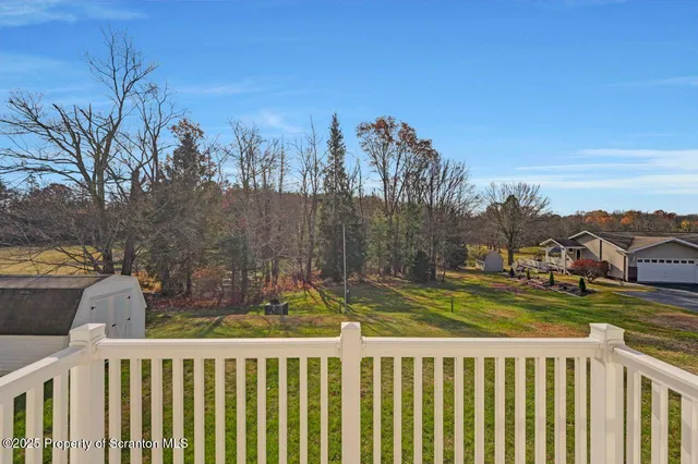 a view of a balcony with chair and wooden floor