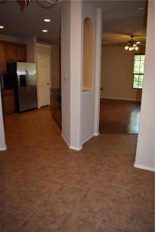 1310 West Parmer Lane, Unit 1503 Austin, TX 78727 - Photo 19 of 26 Kitchen with wood finish cabinets, a ceiling fan, dark countertops, stainless steel fridge, and recessed lighting