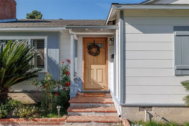 a front view of a house with a garden