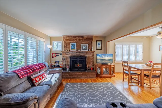 a living room with furniture large window and a fireplace