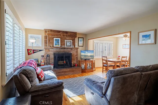 a living room with furniture fireplace and a large window