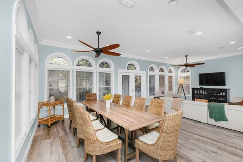 a living room with furniture kitchen view and a flat screen tv