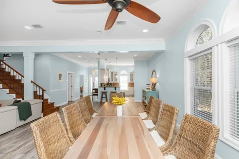 a living room with furniture ceiling fan and a rug