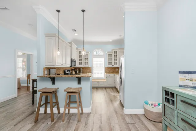 a kitchen with stainless steel appliances granite countertop a refrigerator a stove and a sink