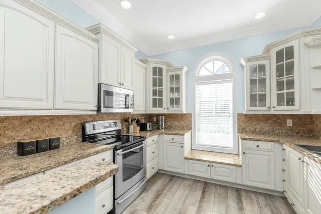 a bedroom with a large bed and a large window