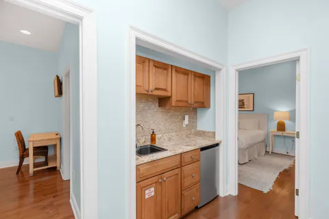 a bedroom with a bed and a painting on the wall