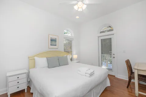 a front view of a house with garden and trees