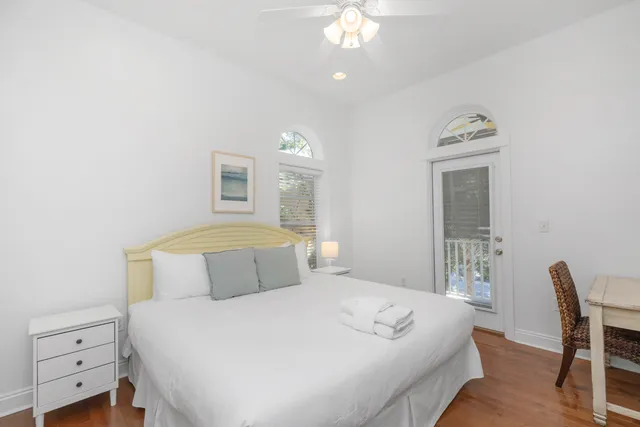 a front view of a house with garden and trees