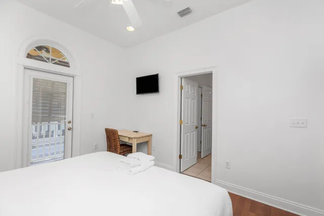 a front view of a house with garden and plants