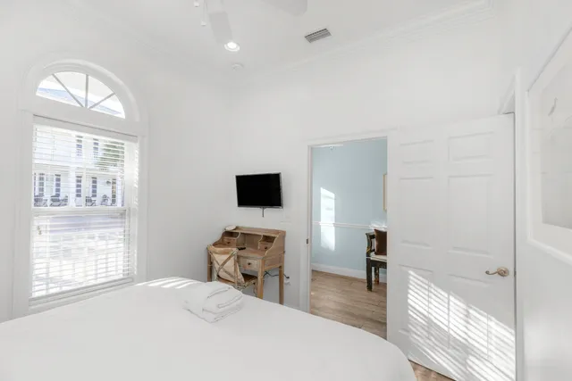 a bathroom with a granite countertop sink a toilet and a mirror