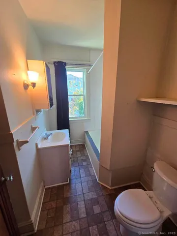 a bathroom with a sink toilet and mirror