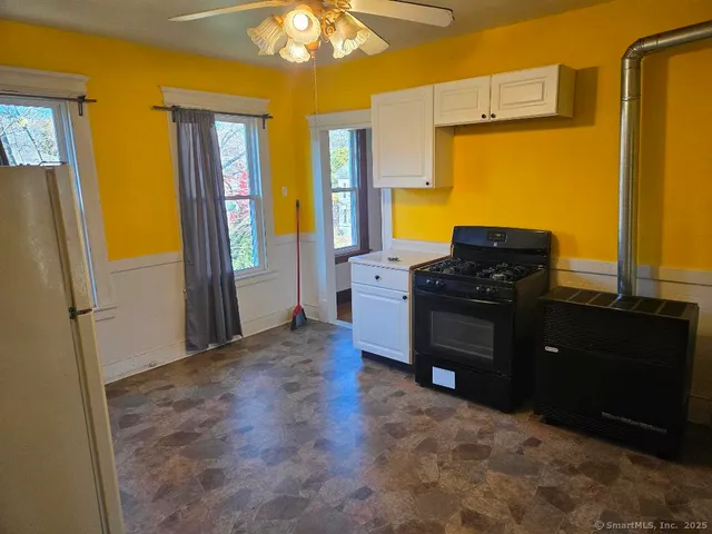 a kitchen with stainless steel appliances granite countertop a refrigerator and a stove