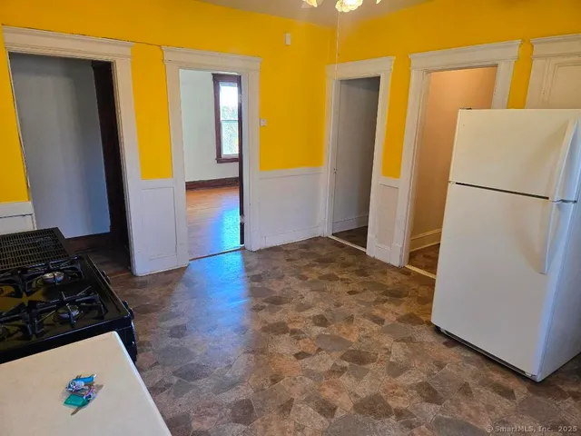 a kitchen with a refrigerator and a stove
