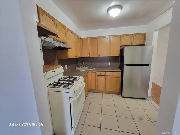 a kitchen with a stove top oven and cabinets