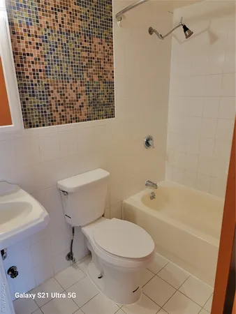 a bathroom with a toilet a sink and bathtub
