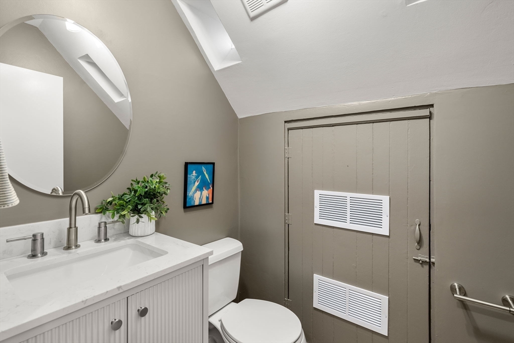 22 Shawmut Street Boston, MA 02116 - Photo 11 of 26 a bathroom with a sink mirror vanity and toilet
