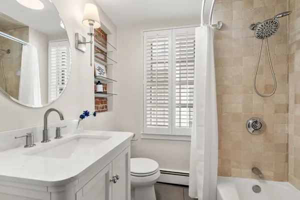 a bathroom with a sink toilet and shower