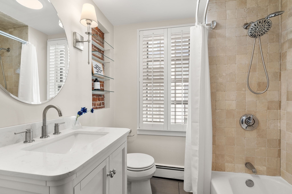 22 Shawmut Street Boston, MA 02116 - Photo 14 of 26 a bathroom with a sink toilet and shower