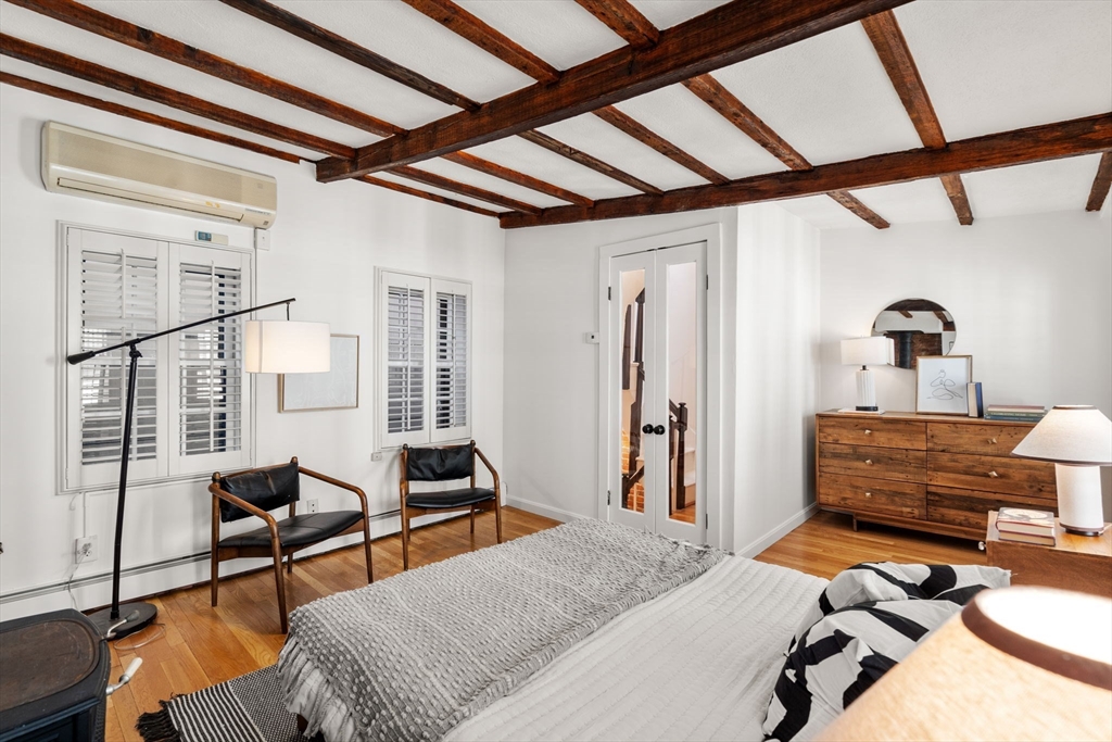 22 Shawmut Street Boston, MA 02116 - Photo 15 of 26 a bedroom with furniture and a window