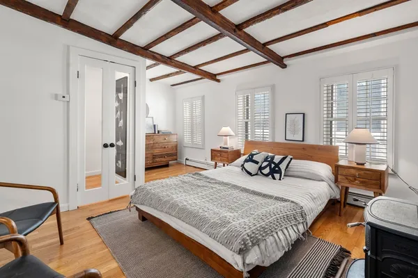 a bedroom with a bed couch and a window