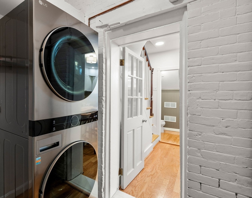 22 Shawmut Street Boston, MA 02116 - Photo 10 of 26 a view of a hallway with washer and dryer