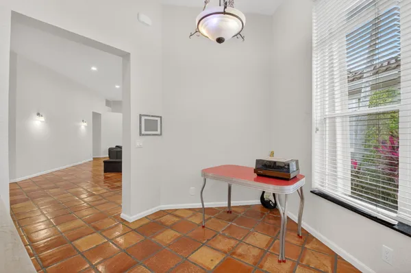 a kitchen with kitchen island a counter top space appliances and a refrigerator