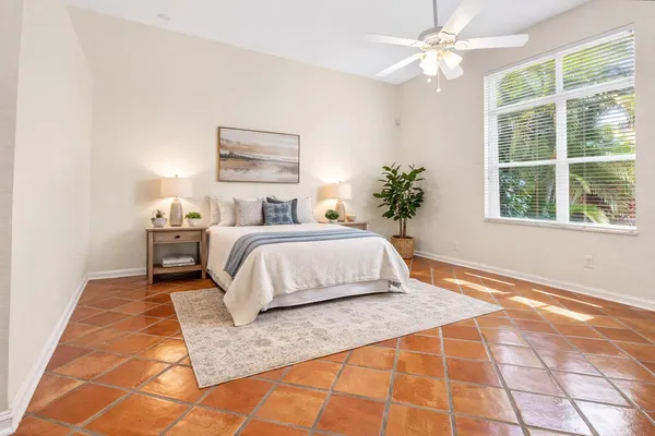 a bedroom with a large bed and a chandelier