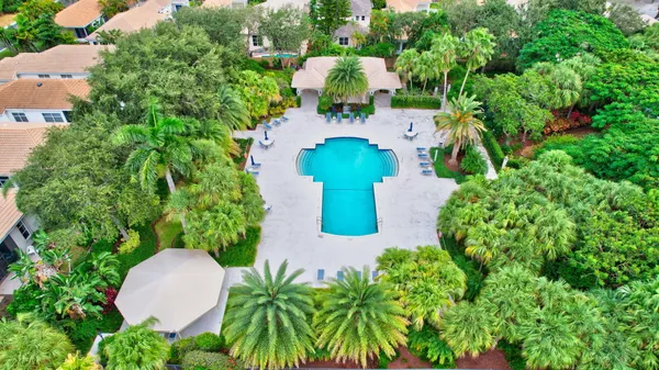 an aerial view of a house with a yard and trees