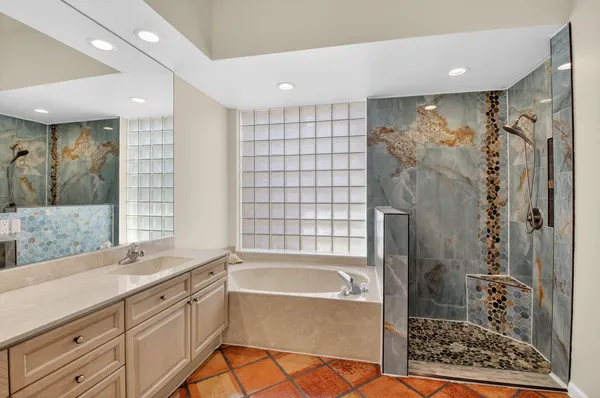 a bathroom with a bathtub and a shower
