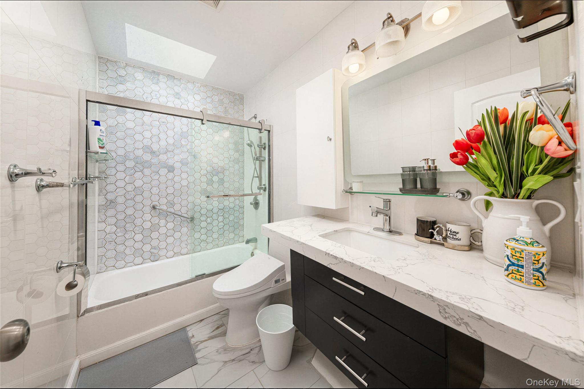 105 Seaman Road Jericho, NY 11753 - Photo 3 of 11 a bathroom with a granite countertop sink a toilet and shower
